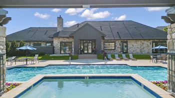 A swimming pool with a house view