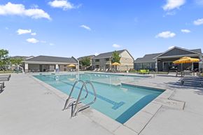 Nampa apartment for rent - A large outdoor swimming pool with a diving board.