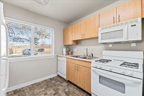 Caldwell apartment for rent - A kitchen with a white fridge, white microwave, white stove and white oven.