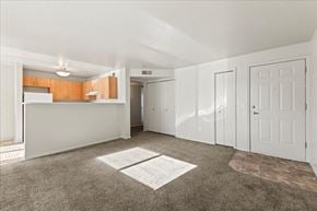 Caldwell apartment for rent - A spacious room with white doors and a carpeted floor.