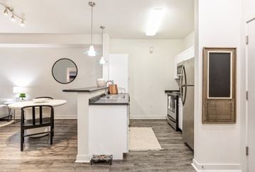 Missoula apartment for rent - a living room with a kitchen and a dining area with a table and chairs