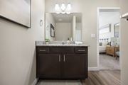 Vineyard apartment for rent - a bathroom with dark cabinets and granite countertops at The Alloy at Geneva, Vineyard, Utah