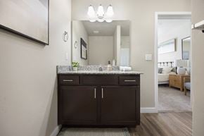 Vineyard apartment for rent - a bathroom with dark cabinets and granite countertops at The Alloy at Geneva, Vineyard, Utah
