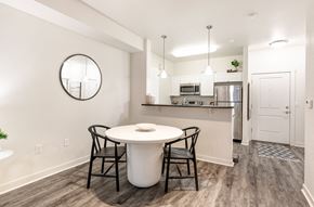 Missoula apartment for rent - a kitchen and dining room with a white table and chairs at Corso Apartments, Missoula, MT
