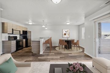 Nampa apartment for rent - A modern kitchen with a dining table set for four.