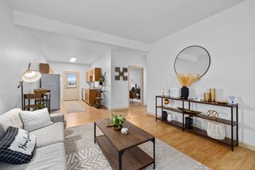 Billings townhouse for rent - A living room with a grey sofa and a wooden coffee table.