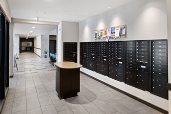 A long hallway with lockers and a table in the center