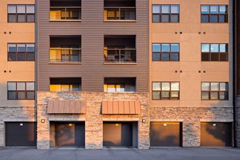 An exterior view of an apartment building with doors and windows