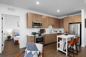 Bozeman apartment for rent - A kitchen with a white table and chairs and a bed in the corner.