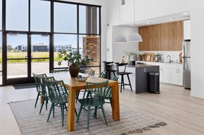 Billings apartment for rent - an open kitchen and dining area with a wooden table and green chairs at The Expo, Montana, 59106