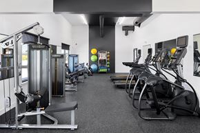 Billings apartment for rent - a spacious exercise room with cardio equipment and weights at The Expo, Billings, MT, 59106