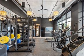 Bozeman apartment for rent - A gym with a variety of equipment including treadmills, weights, and exercise machines.
