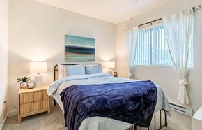 Missoula apartment for rent - a bedroom with a bed and a window with white curtains at Corso Apartments, Missoula, MT