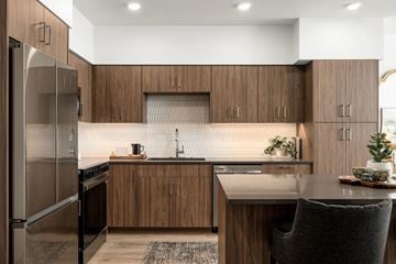 Boise apartment for rent - A modern kitchen with wooden cabinets and a stainless steel refrigerator.