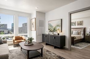 Boise apartment for rent - A modern living room with a large window overlooking the city.