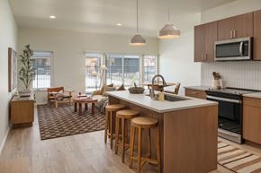 Idaho Falls apartment for rent - A kitchen with a bar area and a dining table.