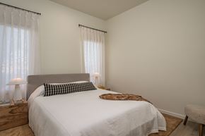 Idaho Falls apartment for rent - A bedroom with a large bed and a chair.