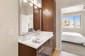 Denver apartment for rent - Modern sytle bathroom vanity with marble-look countertops with a view into the bedroom at Sylvan Uptown, Colorado, 80203