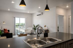 Garden City apartment for rent - a kitchen counter with a sink and a view of a living room at Crosshatch, Idaho, 83714