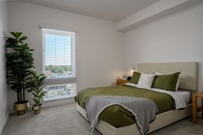 Garden City apartment for rent - a bedroom with a bed and a plant and a window at Crosshatch, Idaho, 83714