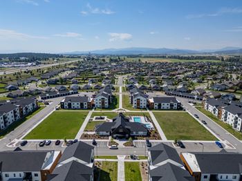 A bird's eye view of a residential area with houses and a park.