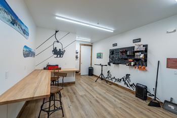 A room with a long wooden table and a bench.