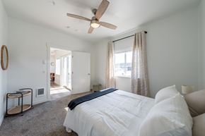 Kalispell apartment for rent - A bedroom with a large bed and a ceiling fan. at Silverbrook Apartments, Kalispell, MT