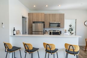 Kalispell apartment for rent - A kitchen with a white counter and four chairs. at Silverbrook Apartments, Kalispell, MT, 59901
