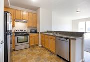 Missoula apartment for rent - A kitchen with wooden cabinets and granite countertops. at Ashlyn Place, Missoula, MT