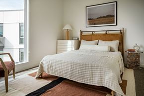 Boise apartment for rent - a bedroom with a bed and a large window