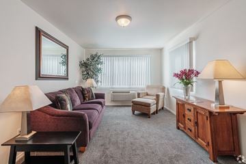 Missoula apartment for rent - A living room with a couch, chairs, and a table with a vase of flowers.
