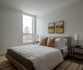 Bozeman apartment for rent - a bedroom with a large bed and two paintings on the wall