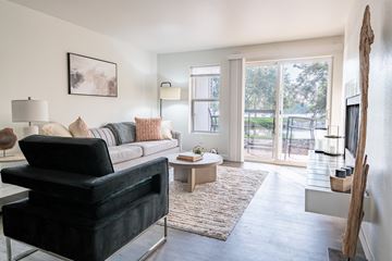 Boise apartment for rent - A living room with a black chair and a white couch.