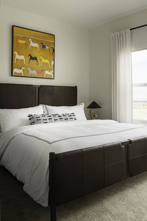 Bozeman apartment for rent - A bedroom with a large bed and a painting of animals above it.
