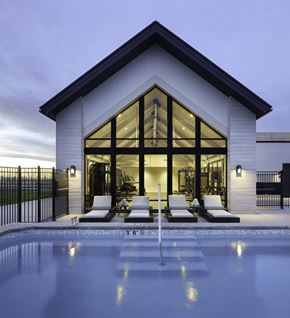 Bozeman apartment for rent - A modern house with a pool in front.