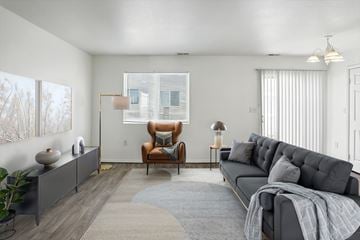 Clearfield apartment for rent - A living room with a grey sofa and a brown armchair.