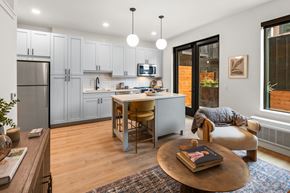 Bozeman apartment for rent - A modern kitchen with a dining table and chairs.