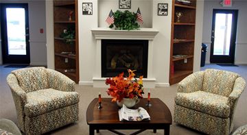 Post Falls apartment for rent - a living room with a fireplace and a table with flowers