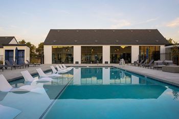 A row of swimming pools with blue water and a blue sky