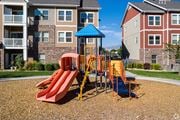 Vineyard apartment for rent - A playground with a red slide and a blue roof at The Alloy at Geneva, Vineyard, 84058