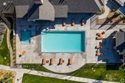 Vineyard apartment for rent - An aerial view of a swimming pool surrounded by orange lounge chairs at The Alloy at Geneva, Vineyard, 84058