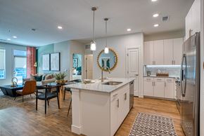 Aurora apartment for rent - an open kitchen and living room with an island and a dining room table