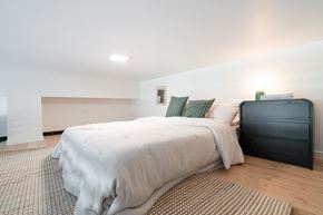 Boise apartment for rent - A bedroom with a bed and a nightstand.