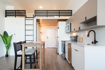 Boise apartment for rent - A modern kitchen with a dining table and chairs.