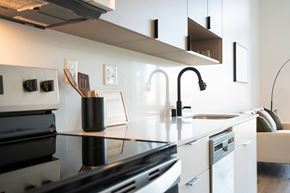 Boise apartment for rent - A modern kitchen with a black stove top oven.