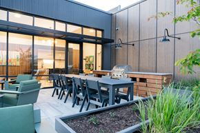 Boise apartment for rent - A modern outdoor dining area with a table and chairs.