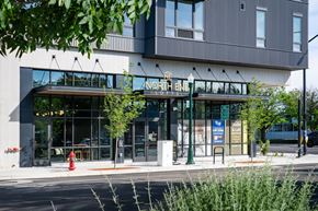Boise apartment for rent - A modern building with a glass entrance and a sign that reads "North End".