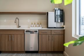 Boise apartment for rent - A kitchen with a stainless steel dishwasher and a coffee machine.