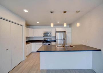 Bozeman apartment for rent - a kitchen with white cabinets and a counter top