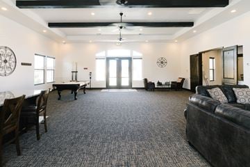 Hurricane apartment for rent - A living room with a black couch and a piano.